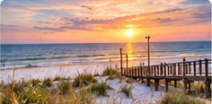 Sunset over a Dauphin Island beach boardwalk